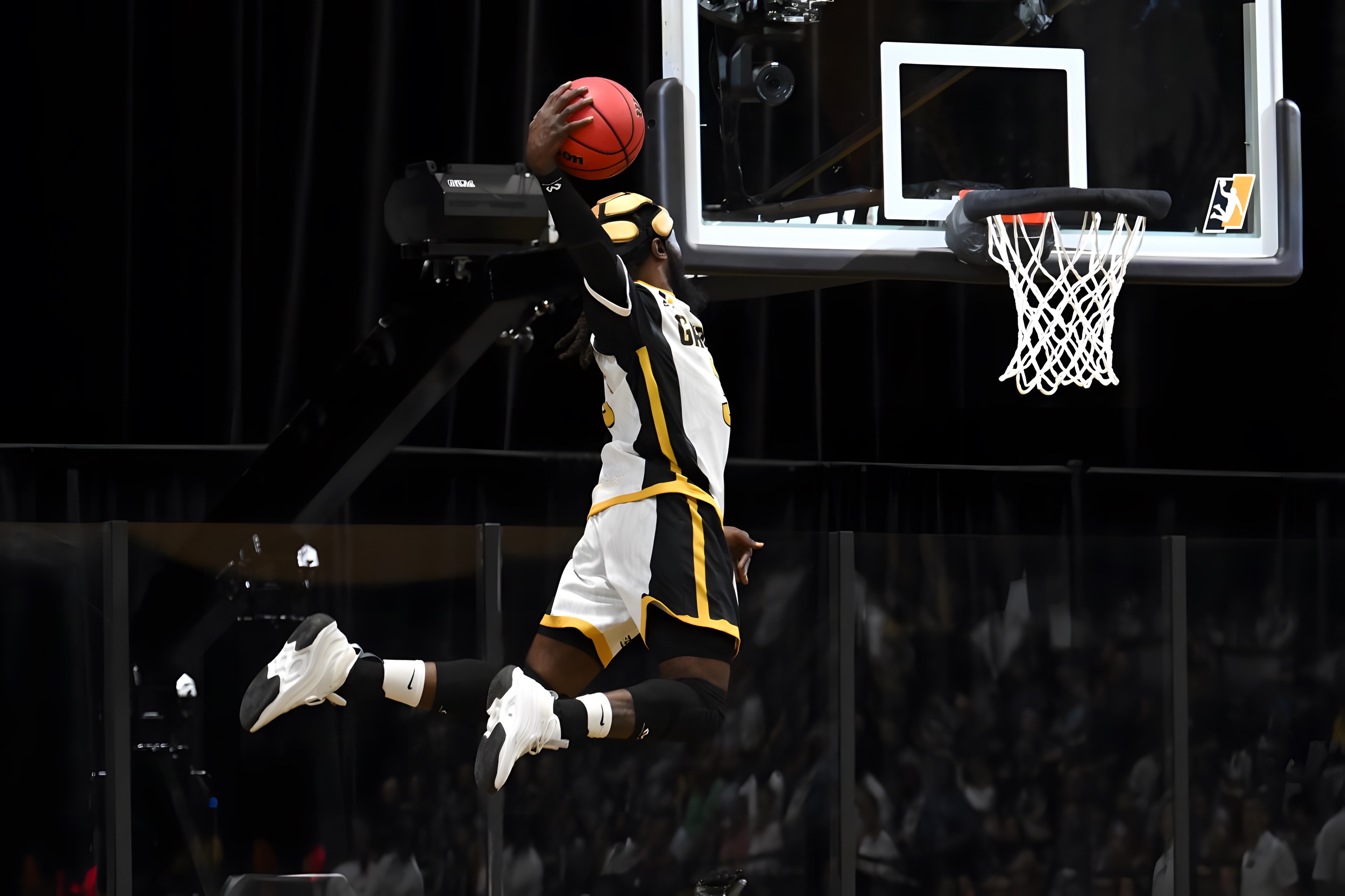 A SlamBall player flying toward the rim off a MaxAir trampoline