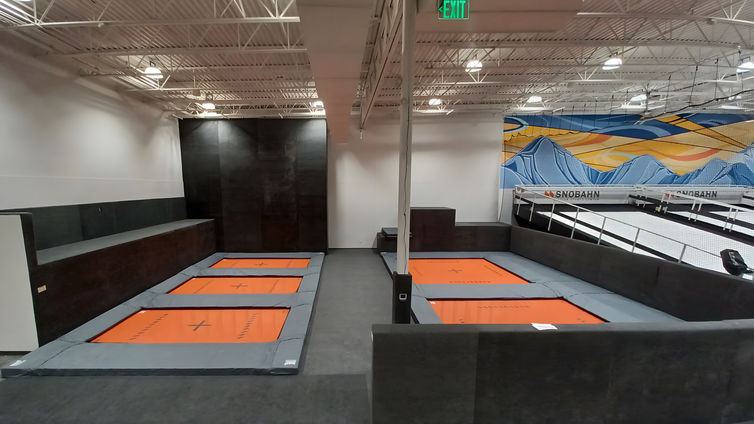 A trampoline court of sunken orange beds at SNÖBAHN
